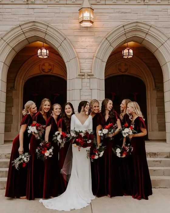 matching burgundy velvet maxi bridesmaid dresses with V-necklines and short sleeves for a winter wedding