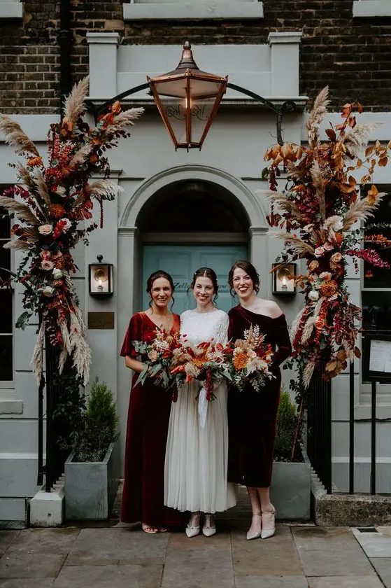 mismatching burgundy and rust-colored velvet bridesmaid dresses are awesome for a fall wedding