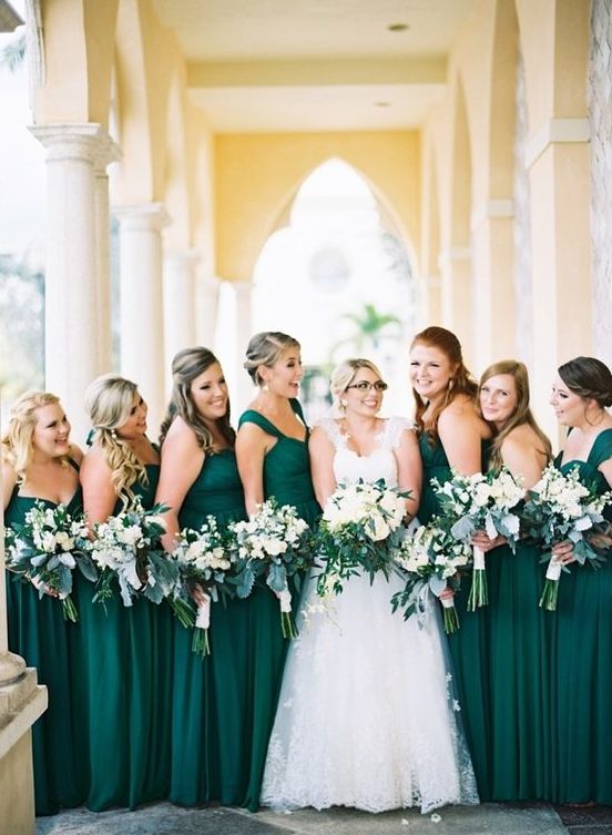 mismatching emerld maxi gowns for the bridesmaids, various neckline but the same color