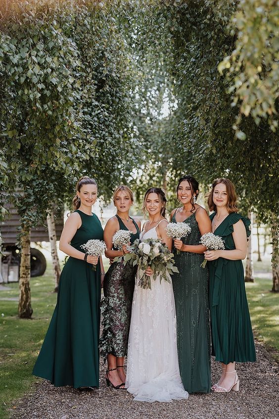 mismatching green midi and maxi bridesmaid dresses with various necklines and detailing are great for a green wedding