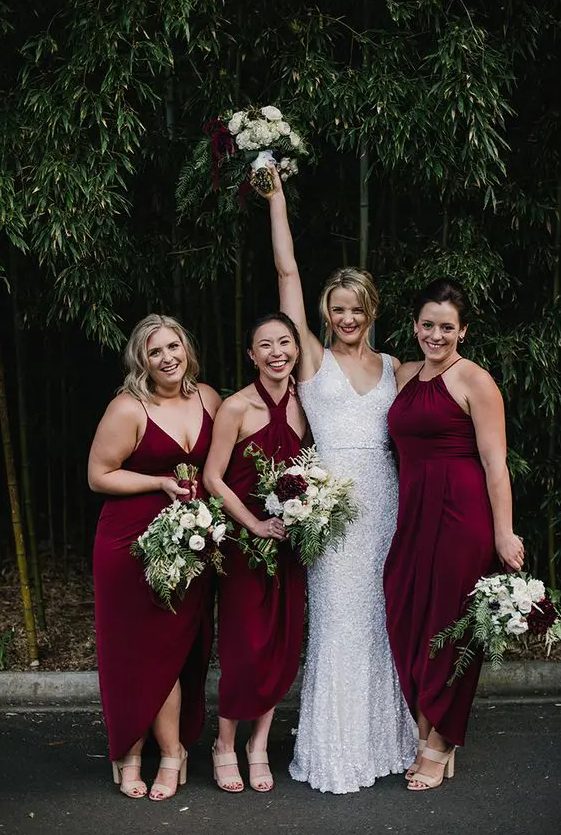 mismatching merlot-colored midi dresses with different necklines and slits for a wow look