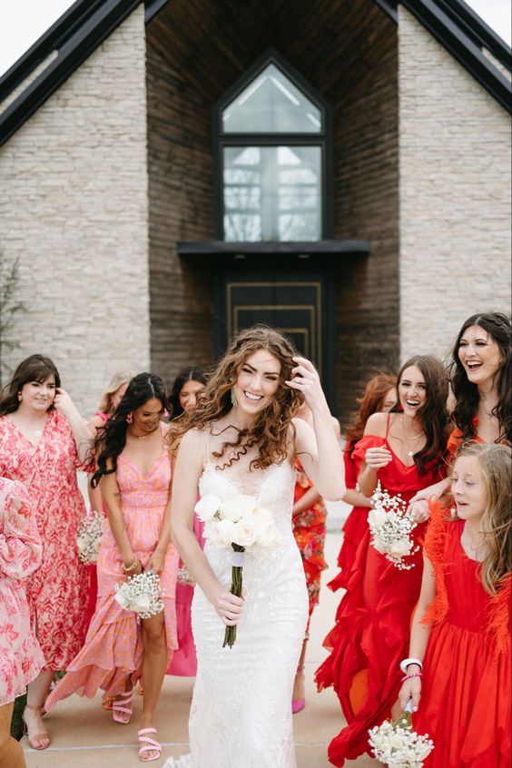 mismatching pink and red bridesmaid dresses of various kinds are adorable for a modern colorful wedding