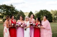mismatching pink and red maxi bridesmaid dresses, plain, ruffle and with floral prints for a modern wedding