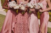 mismatching pink midi bridesmaid dresses of satin and lace are a cool and chic idea for spring and summer weddings