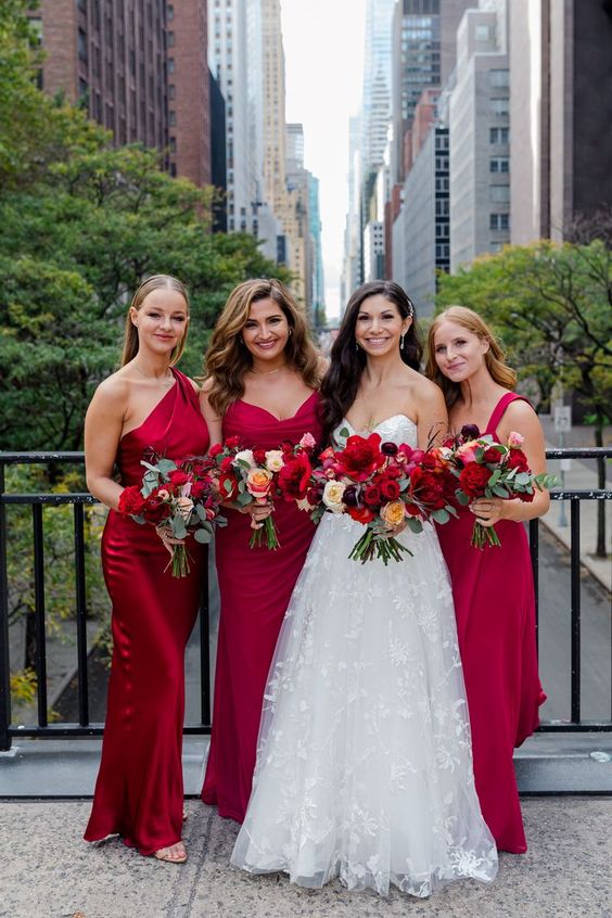 mismatching red maxi bridesmaid dresses are a great idea for a bold and colorful fall wedding