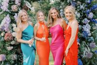 mismatching turquoise, orange, pink and red midi and maxi bridesmaid dresses are fantastic for a colorful wedding