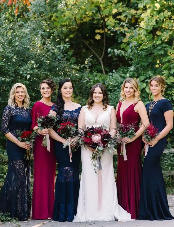 navy and burgundy maxi dresses with lace inserts highlight the white dress of the bride very well