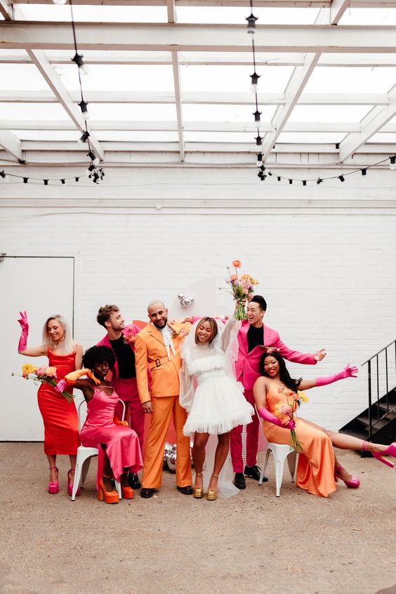orange, red and pink slip midi bridesmaid dresses will add even more color to a colorful wedding