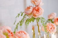 peachy peonies in clear vases and candleholders for refined and chic wedding decor