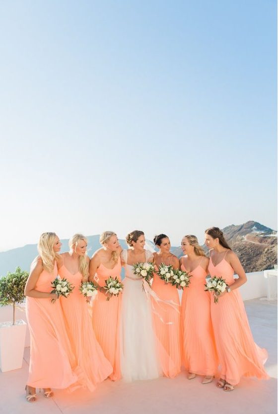 peachy pink A-line bridesmaid dresses with V necklines and spaghetti straps are a lovely solution for a summer wedding