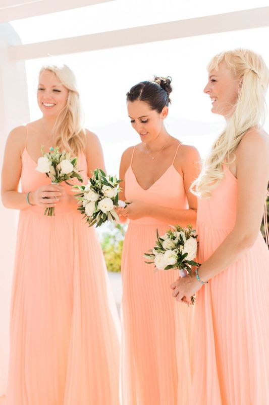 peachy pink spaghetti strap maxi bridesmaid dresses with plated skirts for a bright summer wedding