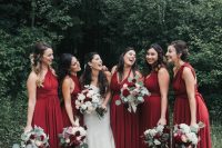 sophisticated burgundy maxi bridesmaid dresses with mismatching necklines are amazing for a fall wedding