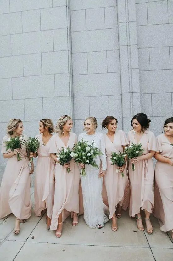 Tender blush wrap maxi bridesmaid dresses with high low skirts, V necklines and short sleeves