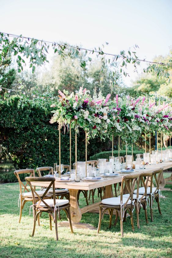pretty tall wedding centerpieces of greenery, pink, blush and deep purple blooms for a summer wedding
