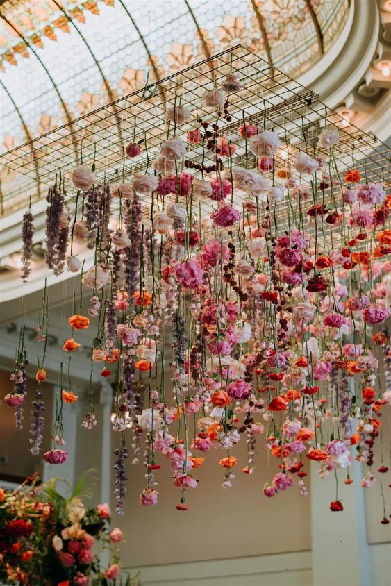 a gorgeous and colorful floral installation for a bold wedding, done with blush, pink, orange and burgundy blooms