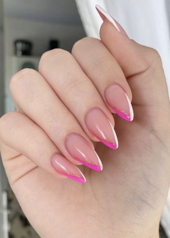 a bold and fun take on classic French nails with a pointed shape and hot pink and white tips accented with pink glitter