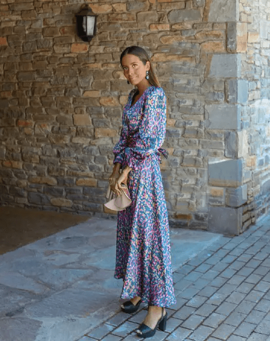 a bright floral print maxi dress with puff sleeves, a blush bag and dark green platform shoes plus dark green earrings