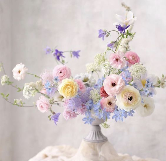 a chic fine art wedding centerpiece of pink, blush, lilac and periwinkle blooms is a lovely idea for a spring celebration