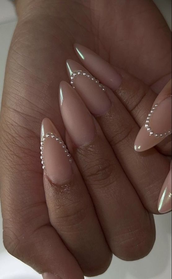 a fab glam French manicure with matching blush yet pearly tips and small beads on some fingers