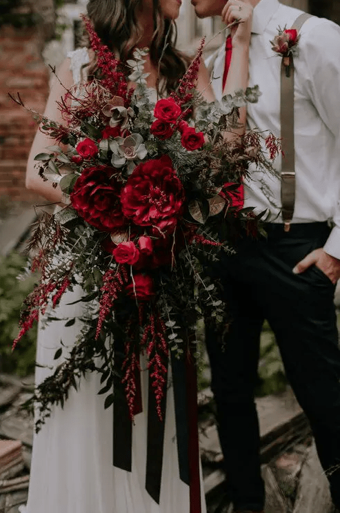 a gorgeous red wedding bouquet of peonies, roses, succulents, greenery, berries and amaranthus is amazing for the fall