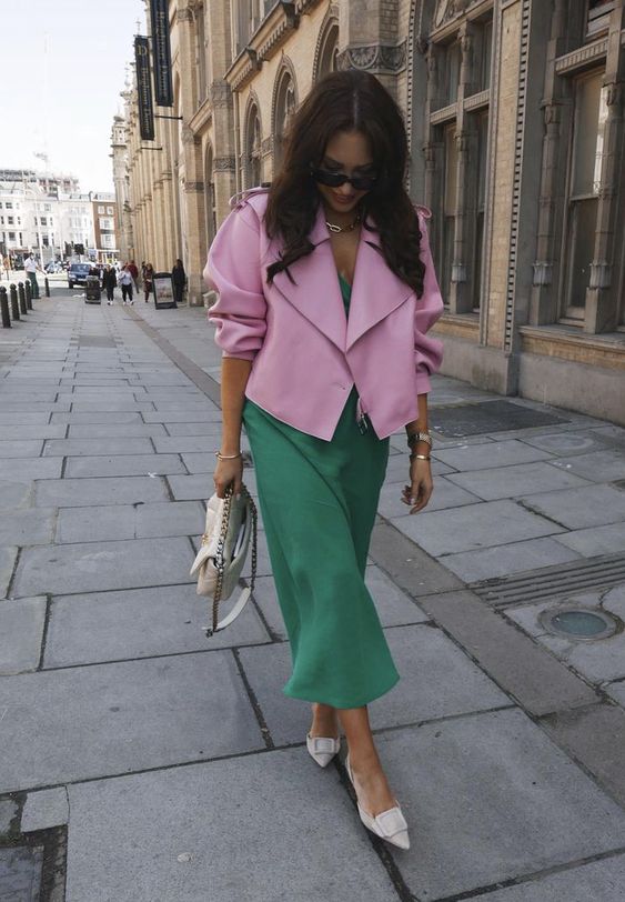 a green slip midi dress, a pink cropped leather jacket, white shoes and a neutral bag for a pretty spring look