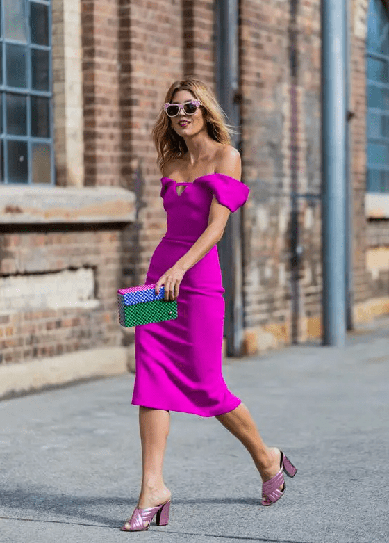 a hot pink off the shoulder dress with a playful neckline, pink metallic shoes and a colorful clutch