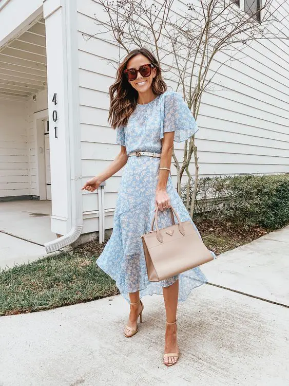 a lovely light blue floral midi dress with short sleeves, a high neckline, a white belt and nude shoes, a tan tote