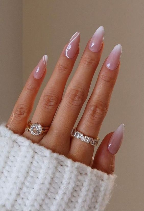 a lovely ombre French manicure with two accent nails done with swirl nail are comprise two trends in one