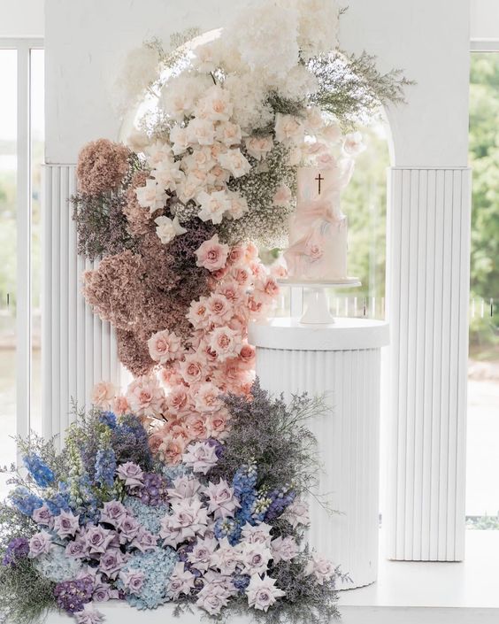 a lush pastel wedding altar of lilac, blue, blush, dusty pink and neutral blooms is a gorgeous solution with an ombre effect