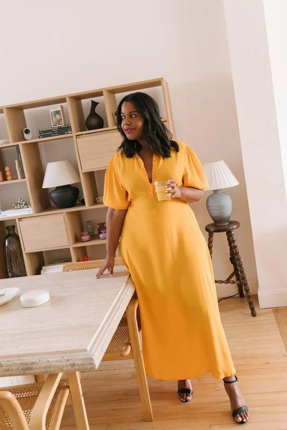 a pretty yellow maxi dress with short puff sleeves and black heeled sandals are a cool look for a bridal shower
