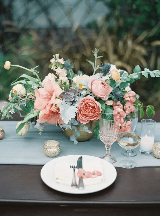 a soft centerpiece with peonies, ranunculus, succulents and textural greenery is a lovely idea, and its soft pink tones are very chic