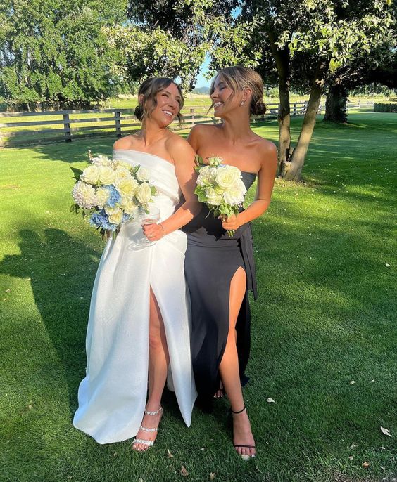 A straples black bridesmaid dresses with a thigh high slit, black shoes for a chic and refined look at the wedding