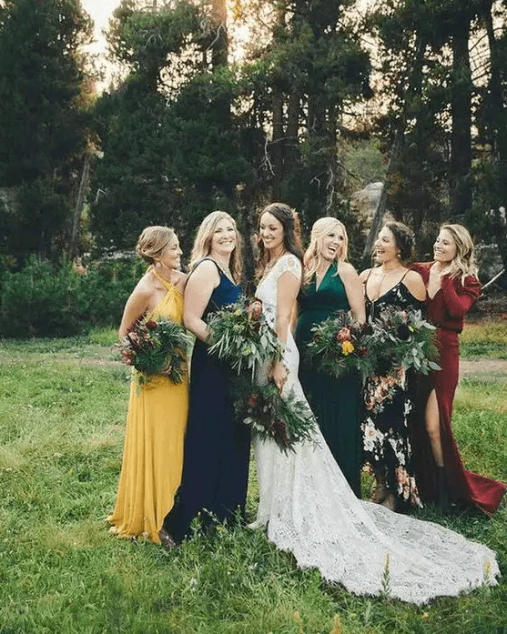 amazing mismatching bridesmaid dresses – a yellow, navy, emerald, burgundy and black floral one for a bright fall wedding