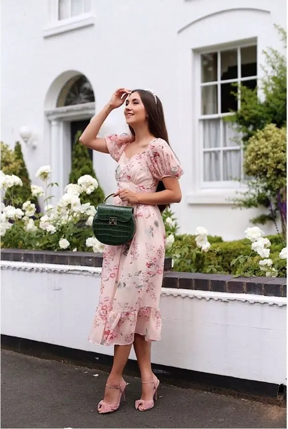 an eye-catchy floral midi dress with puff sleeves, pink shoes and a green mini bag are a cute look for a bridal shower
