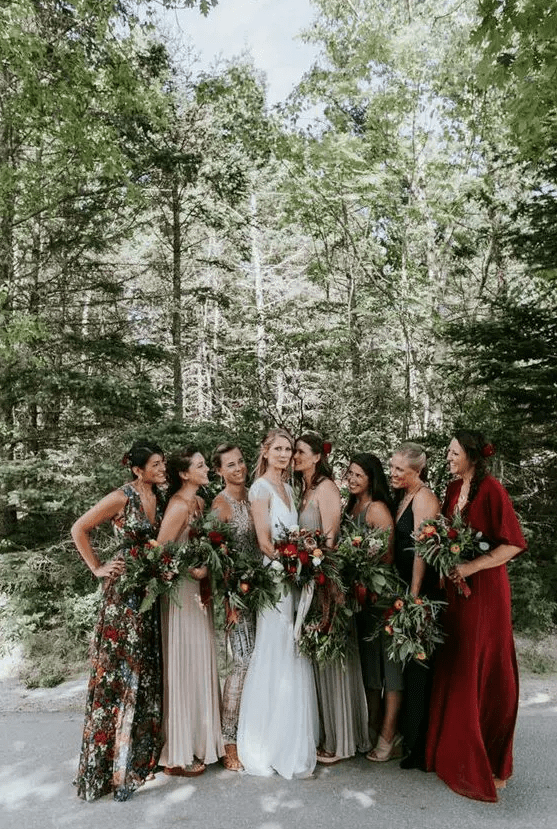 chic mismatched bridesmaids’ maxi dresses with a floral print, in bold red, neutrals and dark shades