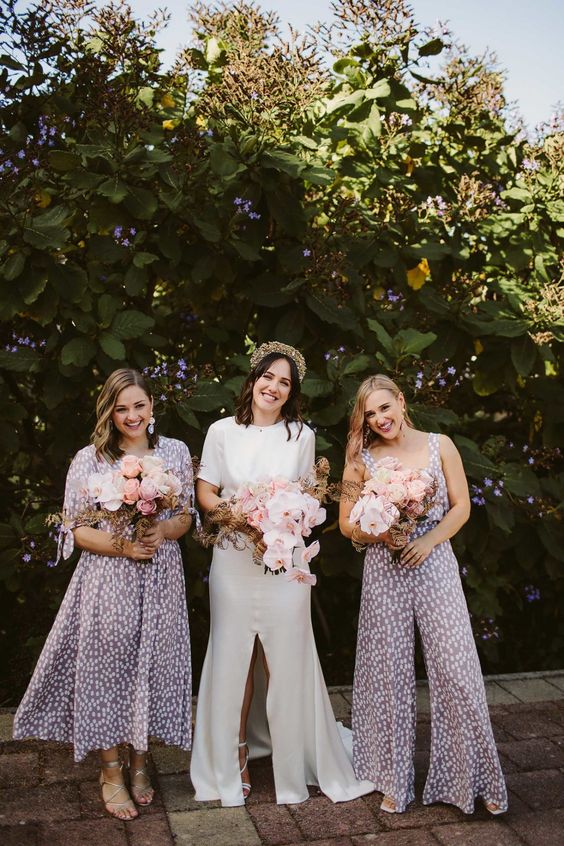 creative matching bridesmaid outfits, a midi dress and a jumpsuit in lilac and white for a spring wedding