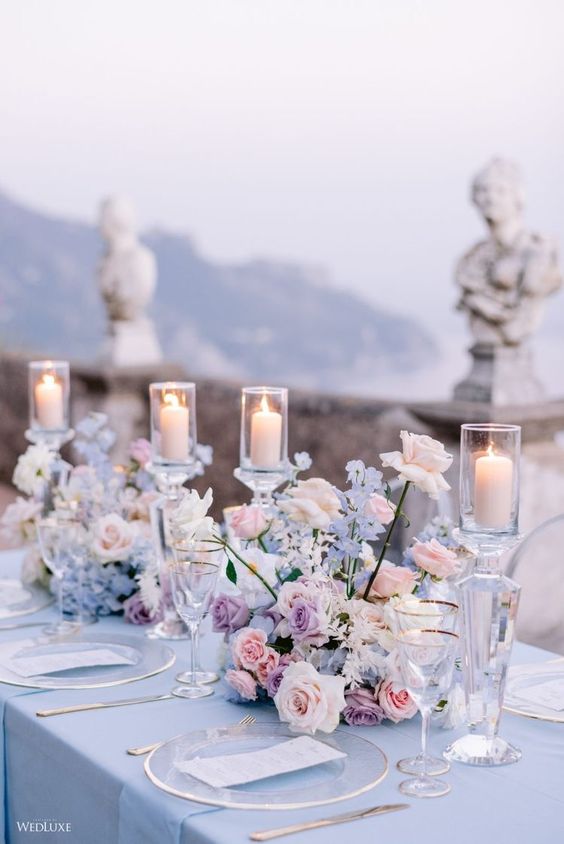 delicate and chic wedding centerpieces of blush, blue and lilac blooms and candles are gorgeous for spring