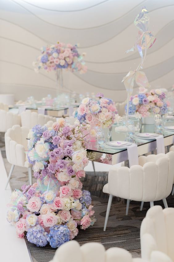 gorgeous pastel wedding centerpiece of pink, lilac and blue flowers and a matching table runner cascading down