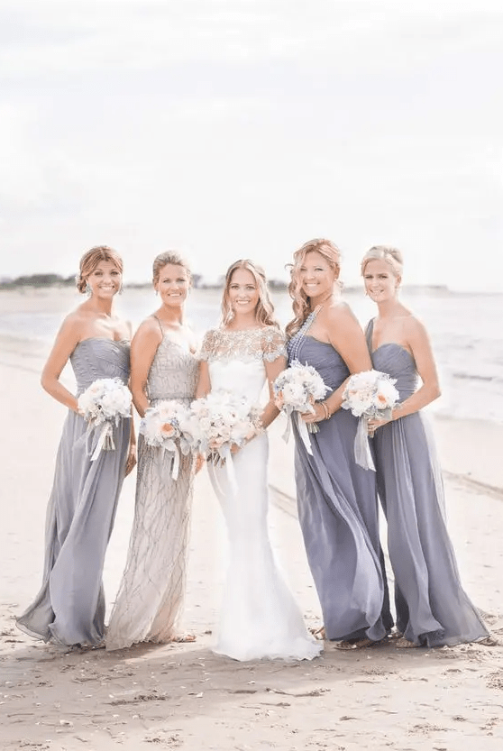 grey strapless and one shoulder maxi dresses for the bridesmaids and an embellished dress for the maid of honor