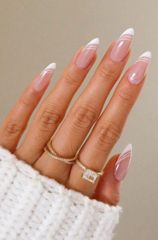 long almond nails with a modern version of French manicure with thin stripes are great for a wedding