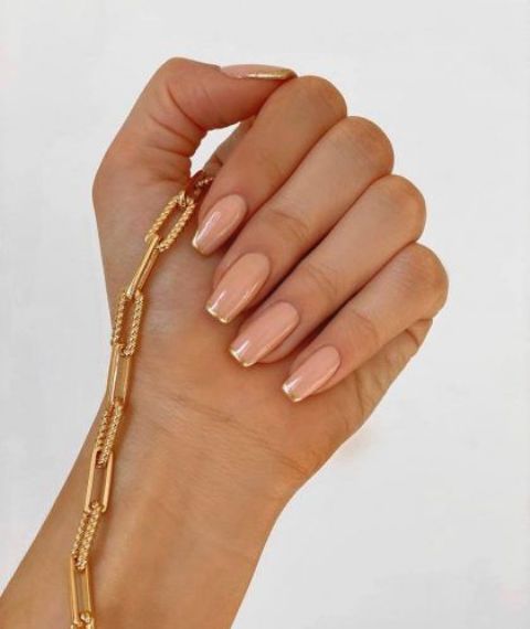 long square nails with gold French tips are a chic and glam idea of a bridal manicure