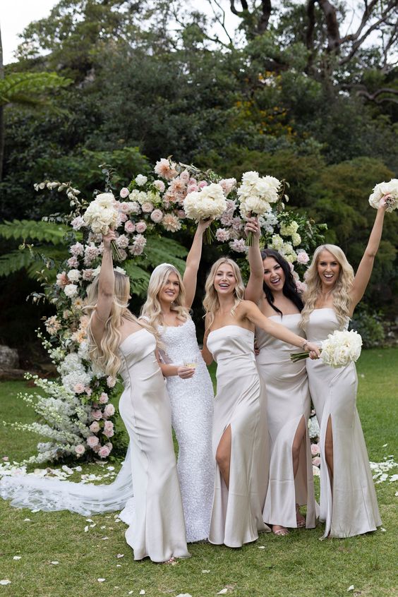lovely white strapless maxi bridesmaid dresses with slits are a cool idea for an all-white wedding