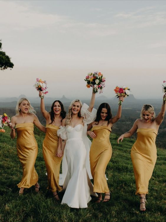 lovely yellow strapless maxi bridesmaid dresses and black shoes are a cool idea for a bold summer wedding