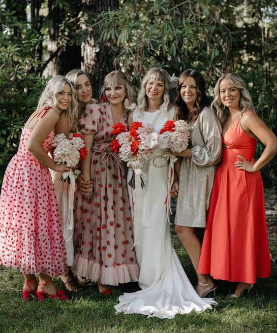 mismatched bridesmaid dresses in pink, white and red, with polka dot and heart prints are a lovely idea for summer