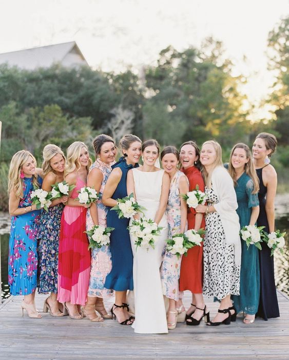 mismatched bridesmaid dresses of various colors and prints are a cool idea for a more relaxed adn eclectic wedding