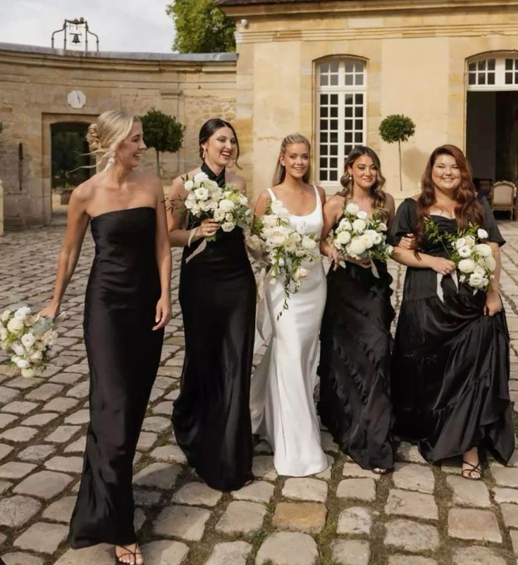 mismatching black maxi bridesmaid dresses, strapless, halter, strap and off the shoulder ones for a formal and chic wedding