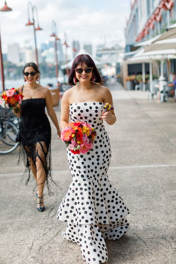 mismatching bridesmaid dresses, a black and white mermaid polka dot one for a black and white wedding