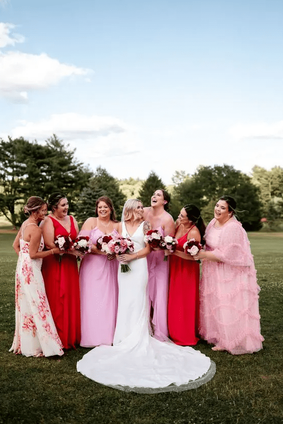 mismatching pink and red maxi bridesmaid dresses, plain, ruffle and with floral prints for a modern wedding