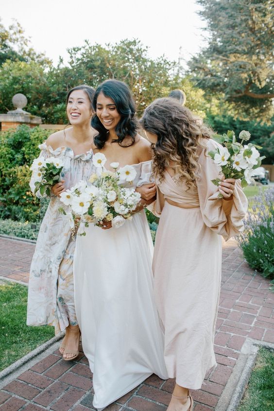 mismatching plain and floral off the shoulder midi bridesmaid dresses and nude shoes for a relaxed summer wedding