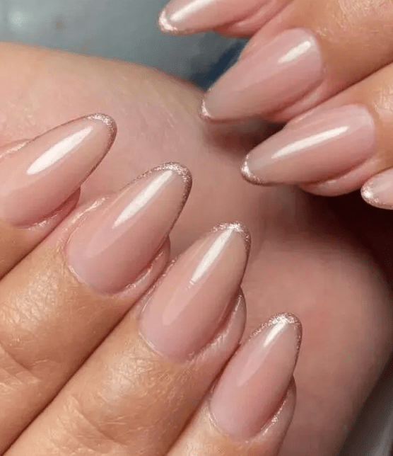 Nude almond shaped nails with rose gold micro tips are a delicate take on a French manicure